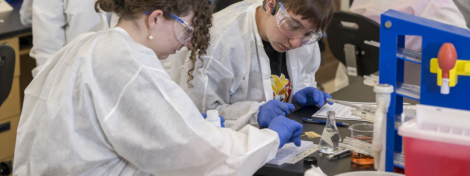 Students conduct forensic science lab work